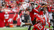  Nebraska Cornhuskers running back Emmett Johnson leaps as the Terrapins try to take him down during the first half.