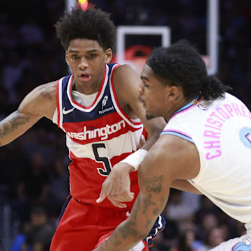 Apr 13, 2025; Miami, Florida, USA;  Miami Heat guard Josh Christopher (8) defends Washington Wizards guard AJ Johnson (5) during the second half at Kaseya Center. Mandatory Credit: Rhona Wise-Imagn Images