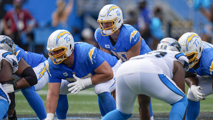 Sep 15, 2024; Charlotte, North Carolina, USA; Los Angeles Chargers quarterback Justin Herbert (10) behind center Bradley Bozeman (75) during the second half against the Carolina Panthers at Bank of America Stadium. Mandatory Credit: Jim Dedmon-Imagn Images