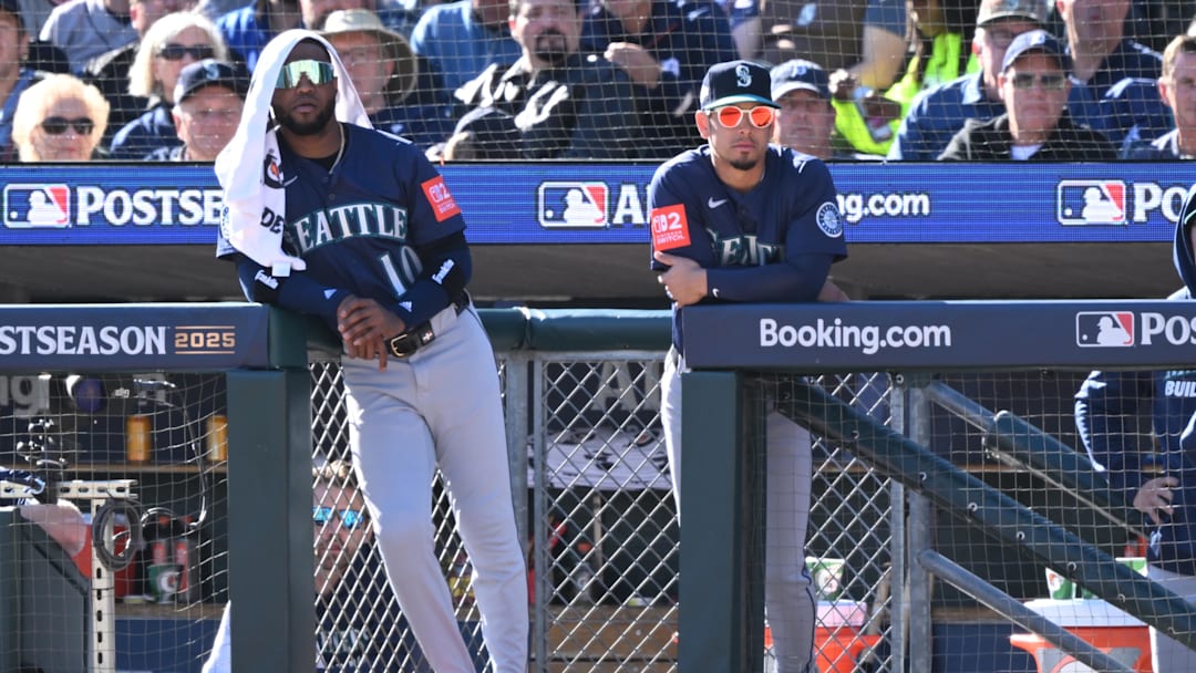 Oct 8, 2025; Detroit, Michigan, USA; Seattle Mariners right fielder Victor Robles (10) and second baseman Leo Rivas (76) look on from the dugout in the third inning during game four of the ALDS round for the 2025 MLB playoffs against the Detroit Tigers at Comerica Park. Mandatory Credit: Lon Horwedel-Imagn Images