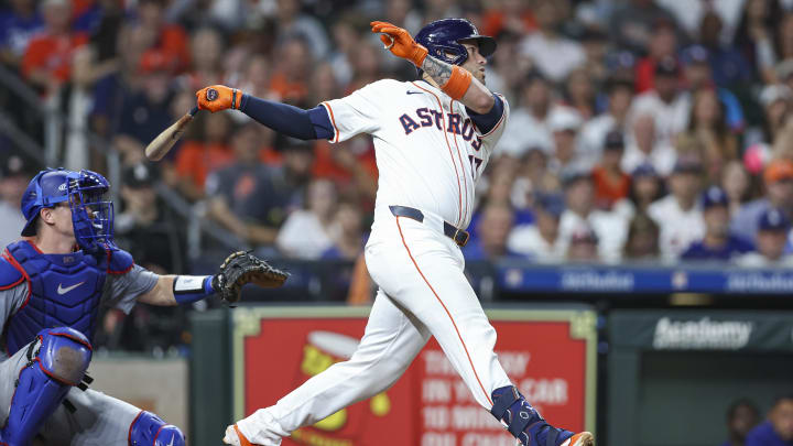 Jul 27, 2024; Houston, Texas, USA; Houston Astros pinch hitter Victor Caratini (17) hits an RBI single during the sixth inning against the Los Angeles Dodgers at Minute Maid Park. Mandatory Credit: Troy Taormina-USA TODAY Sports