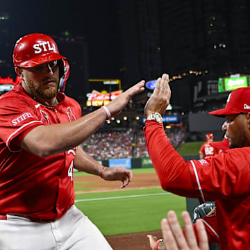 Aug 8, 2025; St. Louis, Missouri, USA;  St. Louis Cardinals catcher Pedro Pages (43) is congratulated by guest coach Yadier Molina (4) after scoring against the Chicago Cubs during the fifth inning at Busch Stadium. Mandatory Credit: Jeff Curry-Imagn Images
