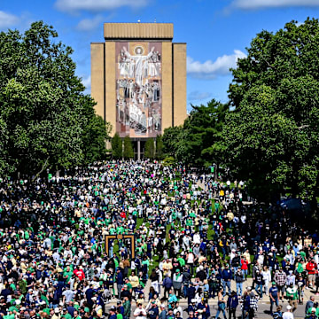 Sep 7, 2024; South Bend, Indiana, USA; Fans gather in front of the Word of Life mural, commonly known as Touchdown Jesus, before the game between the Notre Dame Fighting Irish and the Northern Illinois Huskies at Notre Dame Stadium. Mandatory Credit: Matt Cashore-Imagn Images