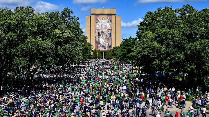 Sep 7, 2024; South Bend, Indiana, USA; Fans gather in front of the Word of Life mural, commonly known as Touchdown Jesus, before the game between the Notre Dame Fighting Irish and the Northern Illinois Huskies at Notre Dame Stadium. Mandatory Credit: Matt Cashore-Imagn Images