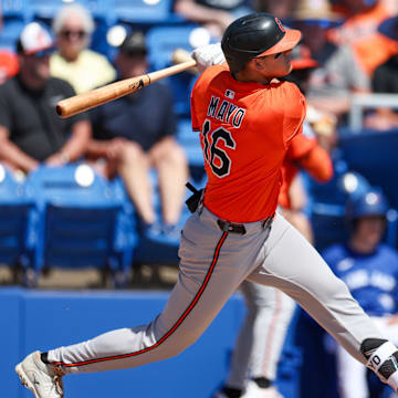 Mar 13, 2025; Dunedin, Florida, USA; Baltimore Orioles third baseman Coby Mayo (16) doubles against the Toronto Blue Jays in the second inning during spring training at TD Ballpark. 