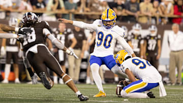 Sep 17, 2022; Kalamazoo, Michigan, USA; Pittsburgh Panthers holder Cam Guess (92) holds the ball for kicker Ben Sauls (90) as Western Michigan Bronco Keni-H Lovely (18) attempts to block the ball in the first quarter at Waldo Stadium. Mandatory Credit: Kimberly Moss-Imagn Images