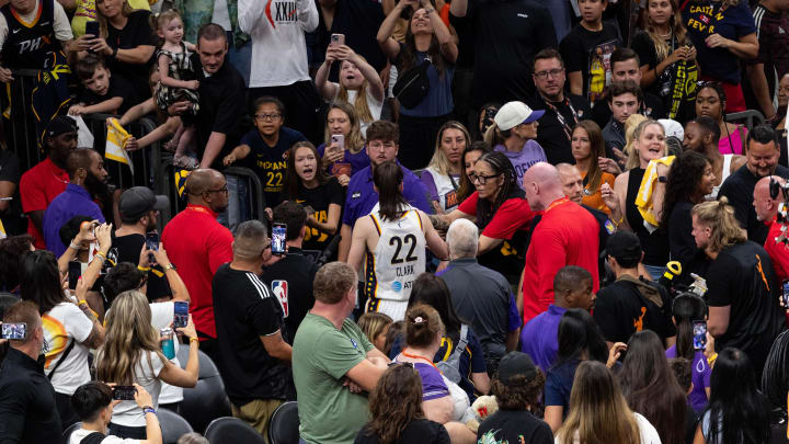 Indiana Fever guard Caitlin Clark (22) signs autographs for fans after defeating the Phoenix Mercury on June 30, 2024, at Footprint Center in Phoenix.