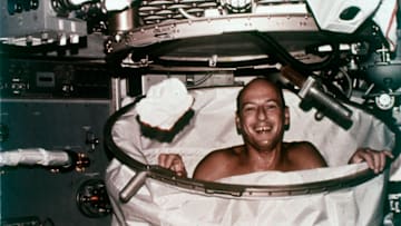 Skylab 2 commander Peter Conrad attempts to take a shower aboard the spacecraft in 1973.