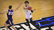 Mar 19, 2021; Indianapolis, IN, USA; Oklahoma State Cowboys guard Cade Cunningham (2) passes the ball past Liberty Flames forward Kyle Rode (22) during the first round of the 2021 NCAA Tournament at Indiana Farmers Coliseum.  Mandatory Credit: Aaron Doster-Imagn Images