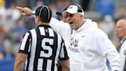 Oct 25, 2025; Pittsburgh, Pennsylvania, USA;  Pittsburgh Panthers head coach Pat Narduzzi (right) reacts to side judge Aaron Hochuli against the North Carolina State Wolfpack during the second quarter at Acrisure Stadium. Mandatory Credit: Charles LeClaire-Imagn Images