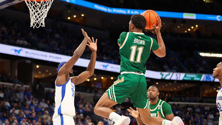 USF guard C.J. Brown  takes it to the basket Friday night at Memphis