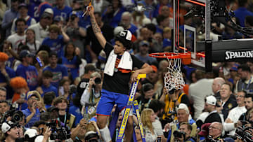 Apr 7, 2025; San Antonio, TX, USA; Florida Gators guard Isaiah Brown (20) cuts the net after defeating the Houston Cougars in the national championship game of the Final Four of the 2025 NCAA Tournament at the Alamodome.Mandatory Credit: Scott Wachter-Imagn Images
