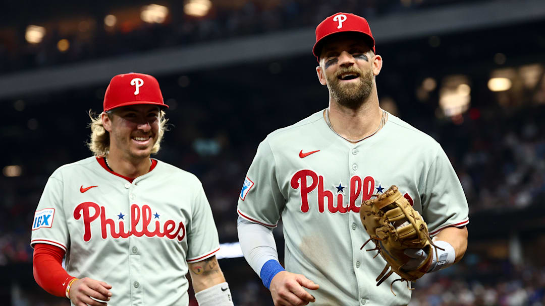 Aug 8, 2025; Arlington, Texas, USA;  Philadelphia Phillies first baseman Bryce Harper (3) laughs with Philadelphia Phillies second baseman Bryson Stott (5) during the game against the Texas Rangers at Globe Life Field. Mandatory Credit: Kevin Jairaj-Imagn Images