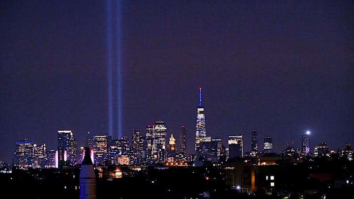 The 9/11 Tribute of Lights rise above New York City skyline honoring the victims from 23 years ago seen from the roof of the Arthur Ashe Stadium.