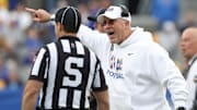 Oct 25, 2025; Pittsburgh, Pennsylvania, USA;  Pittsburgh Panthers head coach Pat Narduzzi (right) reacts to side judge Aaron Hochuli against the North Carolina State Wolfpack during the second quarter at Acrisure Stadium. Mandatory Credit: Charles LeClaire-Imagn Images