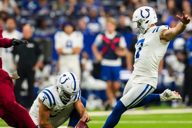 Indianapolis Colts kicker Matt Gay attempts a field goal in a white jersey.