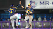 Jul 6, 2025; Miami, Florida, USA; Milwaukee Brewers left fielder Christian Yelich (22) and shortstop Andruw Monasterio (14) celebrate after the game against the Miami Marlins at loanDepot Park. Mandatory Credit: Jim Rassol-Imagn Images