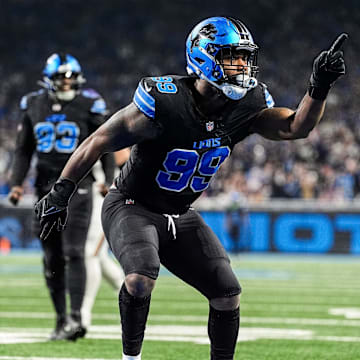 Detroit Lions defensive end Za'Darius Smith (99) celebrates a sack against Minnesota Vikings quarterback Sam Darnold (14) during the first half at Ford Field in Detroit on Sunday, Jan. 5, 2025.