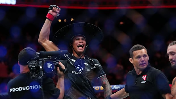 Daniel Zellhuber (red gloves) reacts after defeating Christos Giagos (blue gloves) during UFC Fight Night at T-Mobile Arena.