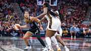 Jul 9, 2025; Indianapolis, Indiana, USA; Golden State Valkyries guard Veronica Burton (22) dribbles shoots the ball while Indiana Fever forward Aliyah Boston (7) defends in the second half at Gainbridge Fieldhouse. Mandatory Credit: Trevor Ruszkowski-Imagn Images