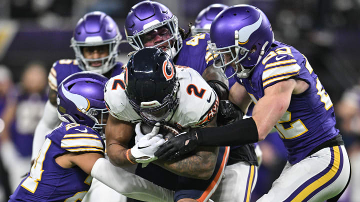 Nov 27, 2023; Minneapolis, Minnesota, USA; Chicago Bears wide receiver DJ Moore (2) is tackled by Minnesota Vikings safety Harrison Smith (right) and safety Camryn Bynum (left) and safety Josh Metellus (44) during the fourth quarter at U.S. Bank Stadium.