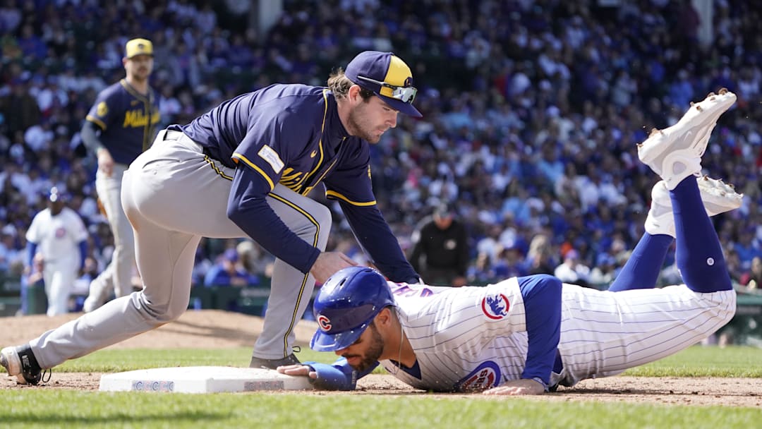May 5, 2024; Chicago, Illinois, USA; Chicago Cubs outfielder Mike Tauchman (40) dives safely into first base as Milwaukee Brewers third base Tyler Black (7) makes a late tag during the seventh inning at Wrigley Field. Mandatory Credit: David Banks-Imagn Images