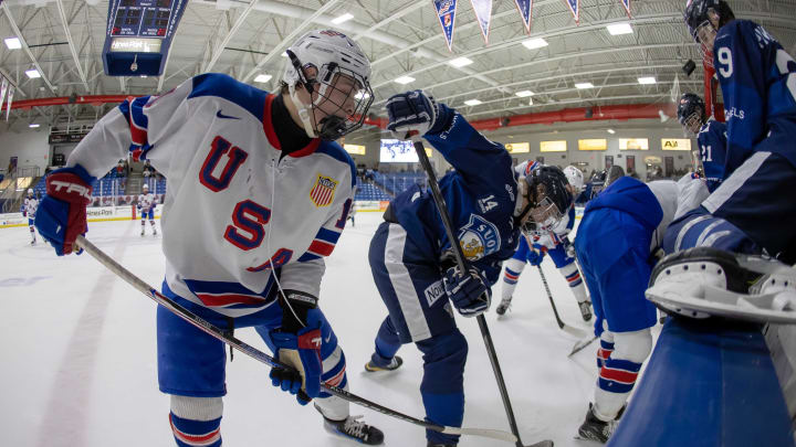 Feb 7, 2024; Plymouth, MI, USA; USA s James Hagens (10) battles along the boards for the puck with Finland's Markus Loponen (14) during the third period of the 2024 U18 s Five Nations Tournament at USA Hockey Arena. Mandatory Credit: David Reginek-USA TODAY Sports