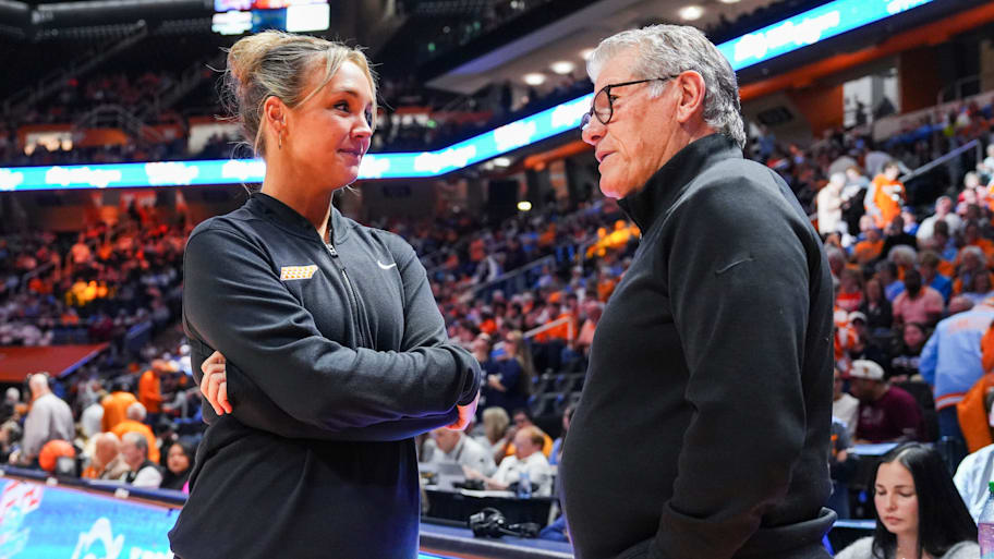 Tennessee head coach Kim Caldwell and UConn head coach Geno Auriemma talk before a game