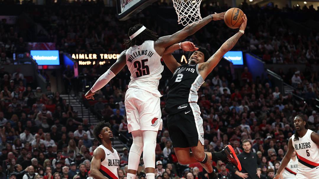 Apr 24, 2026; Portland, Oregon, USA; San Antonio Spurs guard Dylan Harper (2) goes up for a dunk over Portland Trail Blazers center Robert Williams III (35) during the second half during game three of the first round of the 2026 NBA Playoffs at Moda Center. Mandatory Credit: Jaime Valdez-Imagn Images
