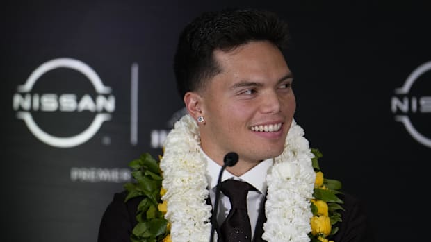 Oregon Ducks quarterback Dillon Gabriel smiles on stage during a press conference before the 2024 Heisman Trophy Presentation