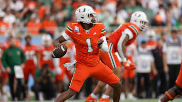 Dec 28, 2024; Orlando, FL, USA; Miami Hurricanes quarterback Cam Ward (1) drops back to pass against the Iowa State Cyclones in the first quarter during the Pop Tarts bowl at Camping World Stadium. Mandatory Credit: Nathan Ray Seebeck-Imagn Images