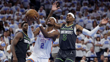 OKC Thunder's Shai Gilgeous-Alexander drives against Minnesota Timberwolves' Jaden McDaniels during the 2025 NBA Playoffs.