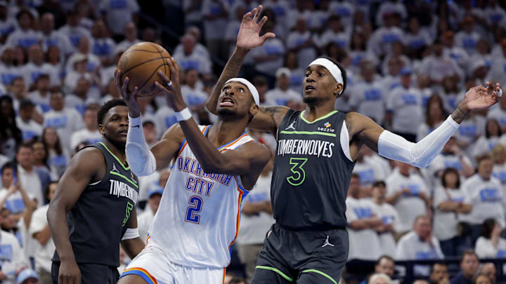 OKC Thunder's Shai Gilgeous-Alexander drives against Minnesota Timberwolves' Jaden McDaniels during the 2025 NBA Playoffs.