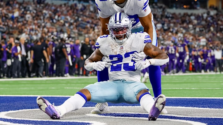 Sep 22, 2024; Arlington, Texas, USA; Dallas Cowboys running back Rico Dowdle (23) is helped up by tight end Brevyn Spann-Ford (89) during the fourth quarter against the Baltimore Ravens at AT&T Stadium. Mandatory Credit: Andrew Dieb-Imagn Images