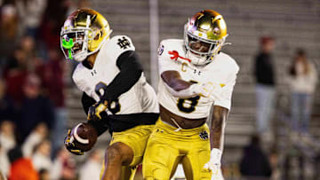 Nov 1, 2025; Chestnut Hill, Massachusetts, USA; Notre Dame safeties Tae Johnson (9) and Adon Shuler (8) leap and celebrate an interception in the fourth quarter against the Boston College Eagles at Alumni Stadium. 