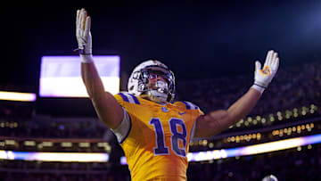 Nov 23, 2024; Baton Rouge, Louisiana, USA;  LSU Tigers running back Josh Williams (18) scores a touchdown against Vanderbilt Commodores linebacker Bryan Longwell (4) during the first half at Tiger Stadium. Mandatory Credit: Stephen Lew-Imagn Images