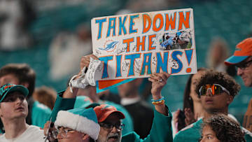 Miami Dolphins fans cheer on their team during warm-ups before the start of a NFL football game