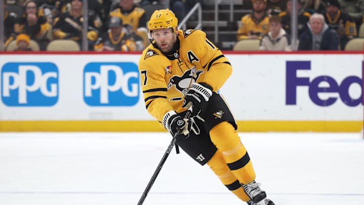 Jan 1, 2026; Pittsburgh, Pennsylvania, USA;  Pittsburgh Penguins right wing Bryan Rust (17) skates up ice with the puck in overtime against the Detroit Red Wings at PPG Paints Arena. Mandatory Credit: Charles LeClaire-Imagn Images