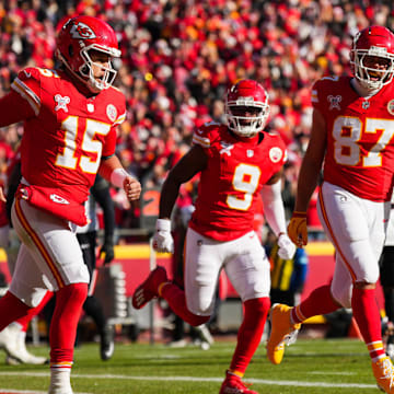 Dec 21, 2024; Kansas City, Missouri, USA; Kansas City Chiefs quarterback Patrick Mahomes (15) celebrates with tight end Travis Kelce (87) and wide receiver JuJu Smith-Schuster (9) after scoring a touchdown during the first half against the Houston Texans at GEHA Field at Arrowhead Stadium. Mandatory Credit: Jay Biggerstaff-Imagn Images