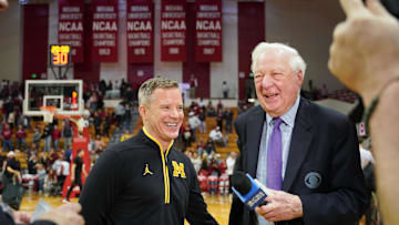 Feb 8, 2025; Bloomington, Indiana, USA; Michigan Wolverines head coach Dusty May talks to CBS broadcaster Bill Raftery after the game Indiana Hoosiers at Simon Skjodt Assembly Hall. Mandatory Credit: Robert Goddin-Imagn Images