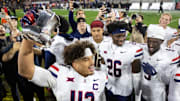 Nov 28, 2025; Tempe, Arizona, USA; Arizona Wildcats defensive back Dalton Johnson (43) celebrates with the Territorial Cup trophy after defeating the Arizona State Sun Devils in the 99th Territorial Cup at Mountain America Stadium. Mandatory Credit: Mark J. Rebilas-Imagn Images