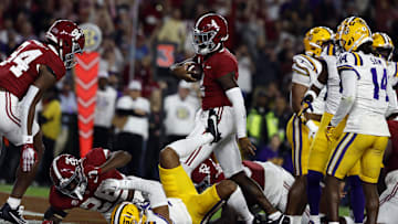Nov 4, 2023; Tuscaloosa, Alabama, USA; Alabama Crimson Tide quarterback Jalen Milroe (4) carries the ball in for a touchdown against the LSU Tigers during the first half at Bryant-Denny Stadium. Mandatory Credit: Butch Dill-Imagn Images