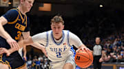 Feb 12, 2025; Durham, North Carolina, USA; Duke Blue Devils forward Cooper Flagg (2) controls the ball in front of California Golden Bears forward Rytis Petraitis (31) during the second half at Cameron Indoor Stadium. Mandatory Credit: Rob Kinnan-Imagn Images