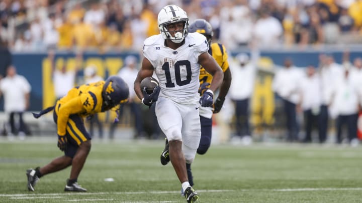 Penn State running back Nicholas Singleton runs the ball for a touchdown during the third quarter against the West Virginia Mountaineers. 