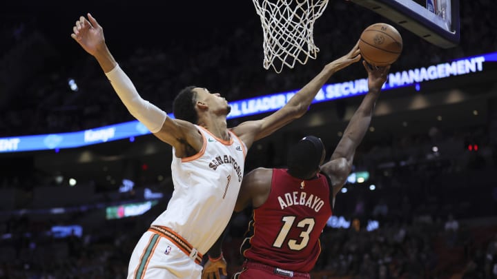 Feb 7, 2024; Miami, Florida, USA; San Antonio Spurs star Victor Wembanyama (1) blocks a shot against Miami Heat center Bam Adebayo (13) during the first quarter at Kaseya Center. 