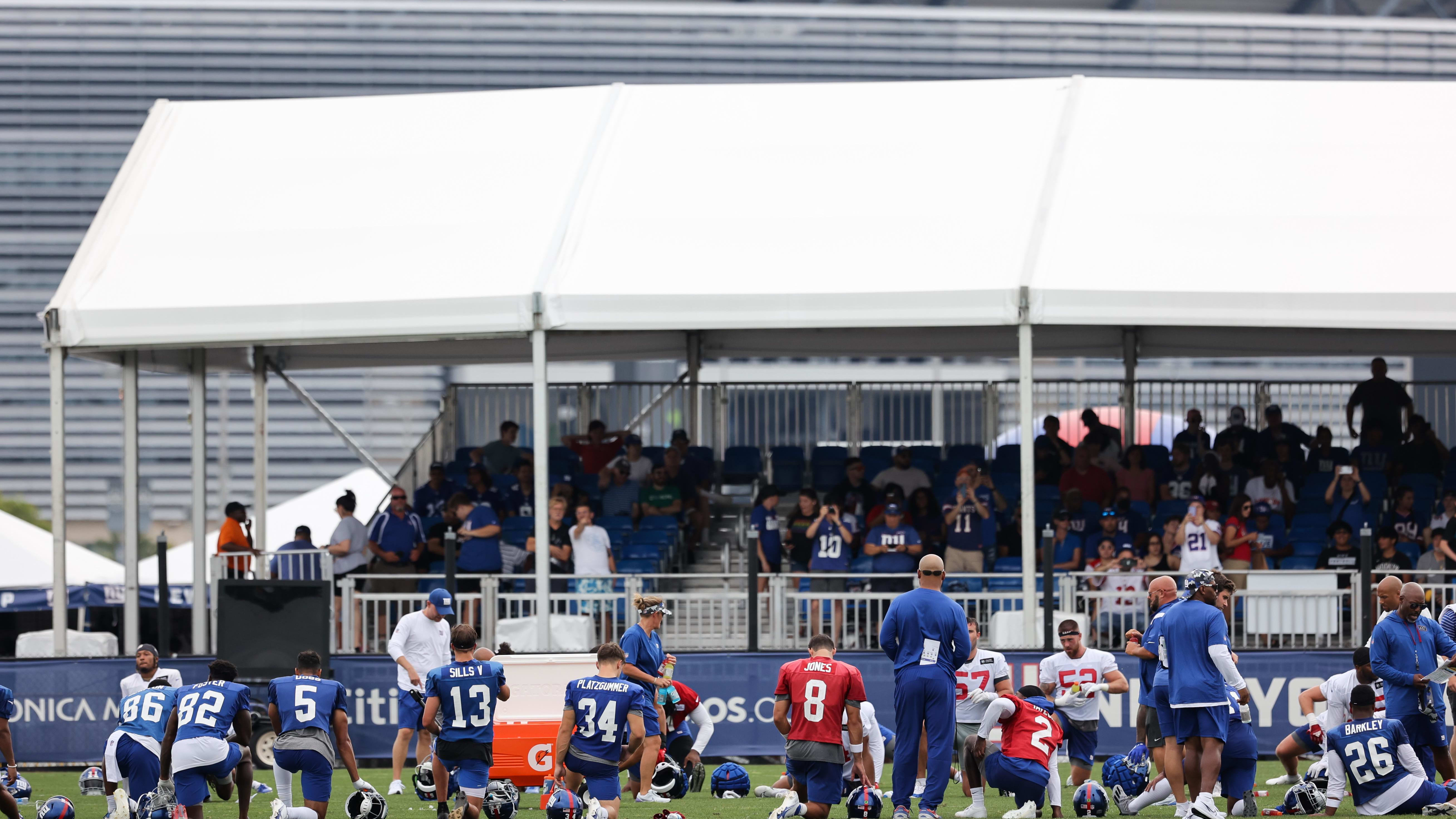 New York Giants players kneel after practice at Quest