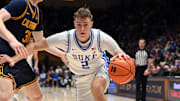 Feb 12, 2025; Durham, North Carolina, USA; Duke Blue Devils forward Cooper Flagg (2) controls the ball in front of California Golden Bears forward Rytis Petraitis (31) during the second half at Cameron Indoor Stadium. Mandatory Credit: Rob Kinnan-Imagn Images