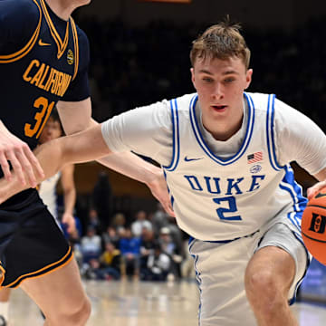 Feb 12, 2025; Durham, North Carolina, USA; Duke Blue Devils forward Cooper Flagg (2) controls the ball in front of California Golden Bears forward Rytis Petraitis (31) during the second half at Cameron Indoor Stadium. Mandatory Credit: Rob Kinnan-Imagn Images