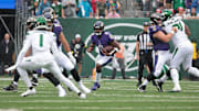 Sep 11, 2022; East Rutherford, New Jersey, USA; Baltimore Ravens quarterback Lamar Jackson (8) carries the ball as New York Jets cornerback Sauce Gardner (1) defends during the first half at MetLife Stadium. Mandatory Credit: Vincent Carchietta-Imagn Images