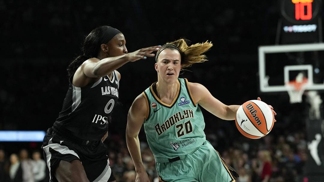 Jun 23, 2026; Las Vegas, Nevada, USA; New York Liberty guard Sabrina Ionescu (20) drives the ball past Las Vegas Aces guard Jackie Young (0) during the third quarter of a WNBA basketball game at Michelob Ultra Arena. Mandatory Credit: Lucas Peltier-Imagn Images